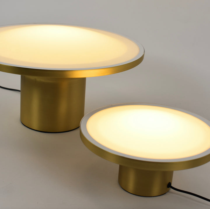 Simbolo Table Lamp with modern disc-shaped design and opal diffuser providing warm ambient light for bedside tables, living rooms and contemporary decor.