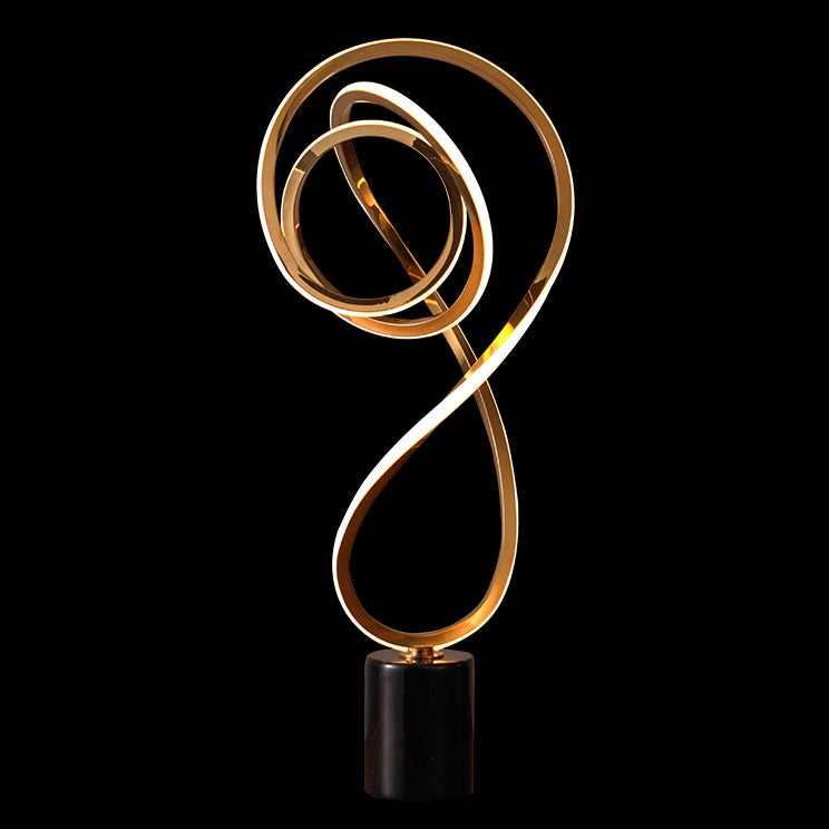 Sonata Table Lamp with sculptural curved LED design in metallic finish ideal for modern living rooms, bedrooms and contemporary decor.