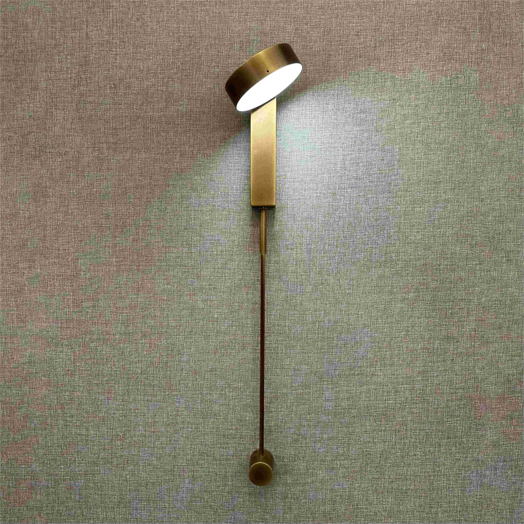 brass adjustable bedside wall lamp with led reading light providing focused modern interior lighting