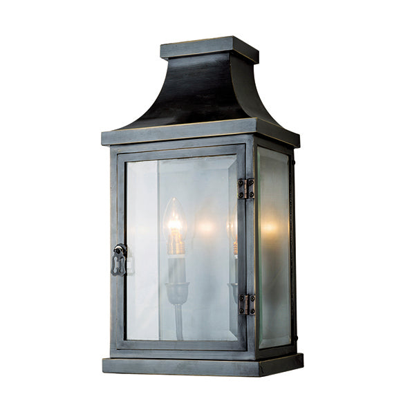 Black exterior wall lantern with tapered roof and clear glass panel.
